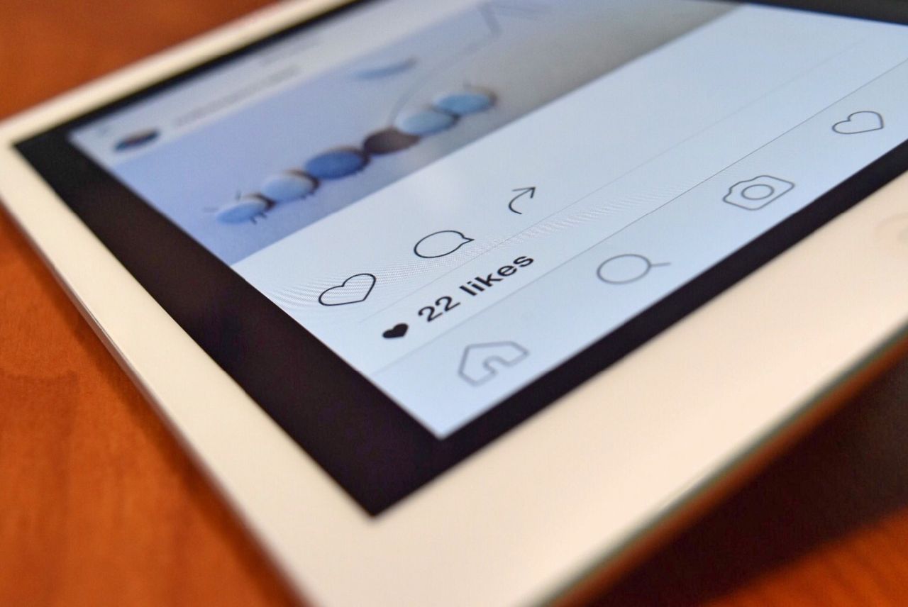 about-01 Photo of a tablet displaying a social media app interface with 22 likes, highlighting digital interaction.